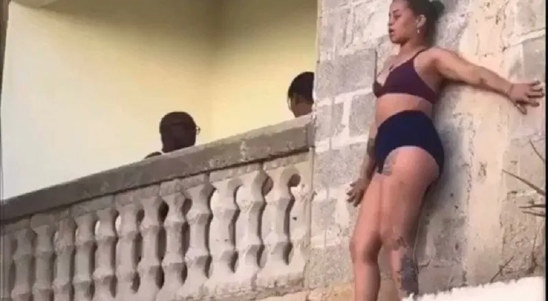 Man gets into argument with his wife, while his side chick hangs from the balcony outside [VIDEO]