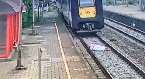 Woman jumps on train tracks and gets run over by a train, but survives [VIDEO]